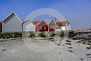 Row Or Line Of Traditional Wooden Beach Huts Facing A Sandy Beach