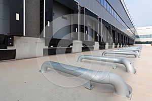 Row of loading docks at a warehouse under the clear blue sky