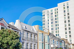 Row of low-rise residential buildings along with the mid-rise building in San Francisco, CA