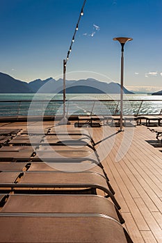Row of lowered empty lounge chairs on Lido Deck of cruise ship. Alaska, USA.