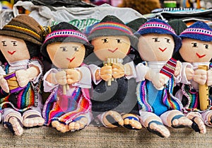 Row of male rag dolls in traditional clothes playing musical instruments, Otavalo Market, Ecuador
