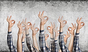 Row of man hands showing okay gesture