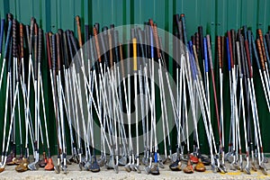 Row of Many Old Used Golf Clubs for Sport