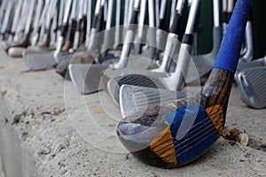 Row of Many Old Used Golf Clubs for Sport