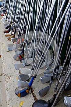 Row of Many Old Used Golf Clubs for Sport