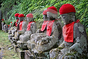 Row of many stony sculptures of buddhas (Kanmangafuchi) in Nikko, Japan