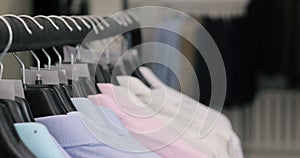 Row of men suit jackets and shirts on hangers