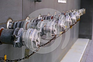 Row of metallic fire hydrants linked with a chain