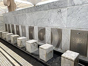 A row of modern ablution (wudu) stations in a mosque.