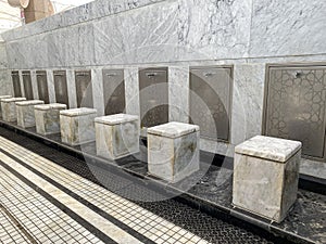 A row of modern ablution (wudu) stations in a mosque.
