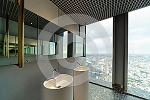 Row of modern white ceramic wash basin in public toilet with cit