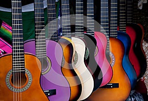 Row of multi-colored Mexican guitars