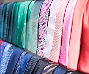 Row of Neckties on hangers in men clothing store