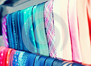 Row of Neckties on hangers in men clothing store