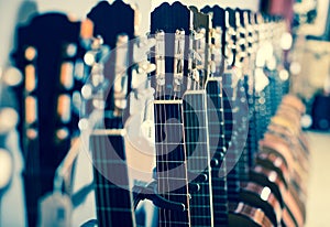 Row of new acoustic guitars in music shop