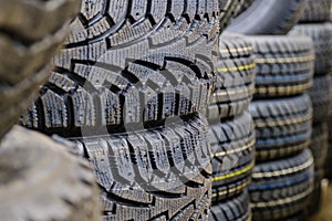 Row of new car tires at tire store. closeup tires in store for sale