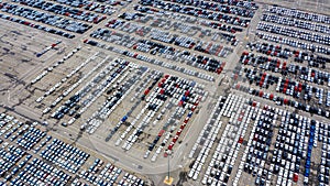 Row of new cars for sale in port at cars export terminal
