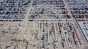 Row of new cars for sale in port at cars export terminal