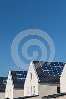 Row of new houses with solar panels on the roofs