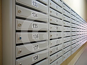 A row of new mailboxes on the porch wall