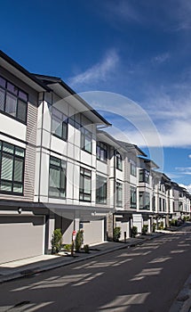 A row of a new townhouses. External facade of a row of colorful modern urban townhouses.brand new houses just after construction o