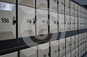 Row of numbered lockers with combination dial lock.