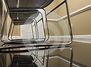 A row of office lobby waiting chairs and white door gray and chrome