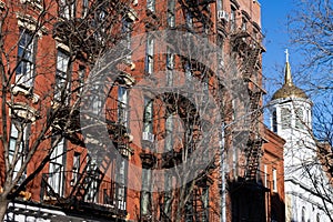 Row of Old Brick Apartment Buildings with Fire Escapes in Greenwich Village of New York City