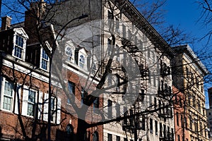 Row of Old Brick Homes and Apartment Buildings with Fire Escapes in Greenwich Village of New York City