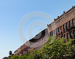 Row of Old Brick Residential Buildings in Greenpoint Brooklyn New York with a Clear Blue Sky