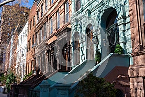 A Row of Old Colorful Brownstone Townhouses with Staircases on the Upper West Side of New York City