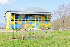 Row of old colorful wooden beehives in the trailer