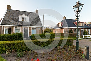 a row of old Dutch traditional houses during sunrise on the wadden island of Schiermonnikoog photo