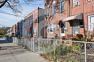 A Row of Old Fenced In Homes in Astoria Queens New York