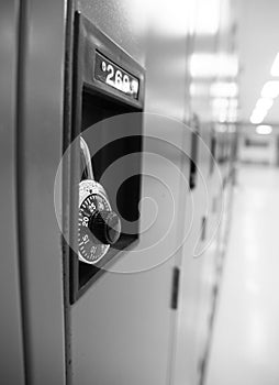 Wall of lockers in a school hall in black and white