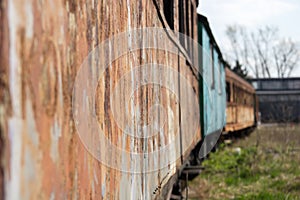 A row of old rusty carriages fastened together