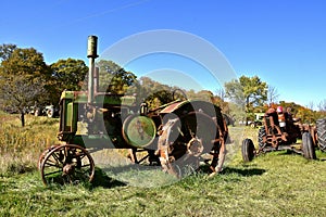 Row of old rusty tractors