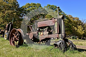 Row of old rusty tractors