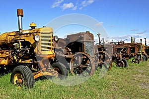 Row of old rusty tractors