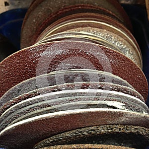 Row of old used sanding discs in a tradesman`s workshop