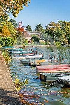 Row of old vintage colorful boats on the lake of Enghien les Bains near Paris France