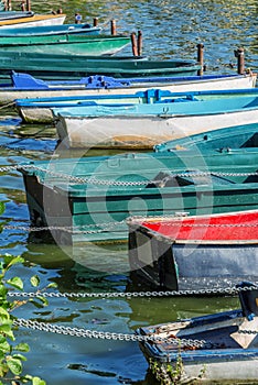 Row of old vintage colorful boats on the lake of Enghien les Bains near Paris France