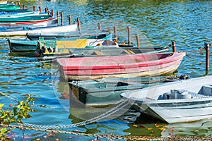 Row of old vintage colorful boats on the lake of Enghien les Bains near Paris France