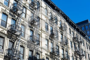 Row of Old White Stone Buildings with Fire Escapes on the Lower East Side of New York City