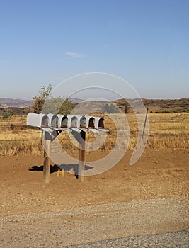 Row of open mailboxes in a rural setting