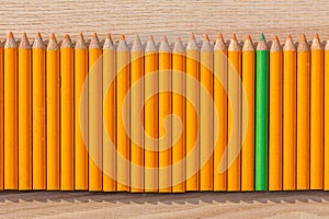 Row of orange and green pencil