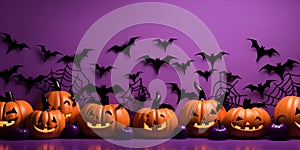 A row of orange pumpkins against a purple background with copy space - Halloween background