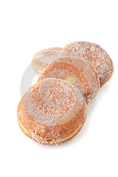 Row of paczki donuts on white