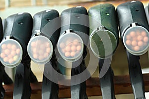 Row of paintball guns on a rack