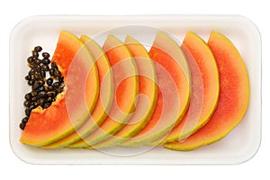Row of papaya slices in plastic packaging isolated on white background, healthy eating concept, close up